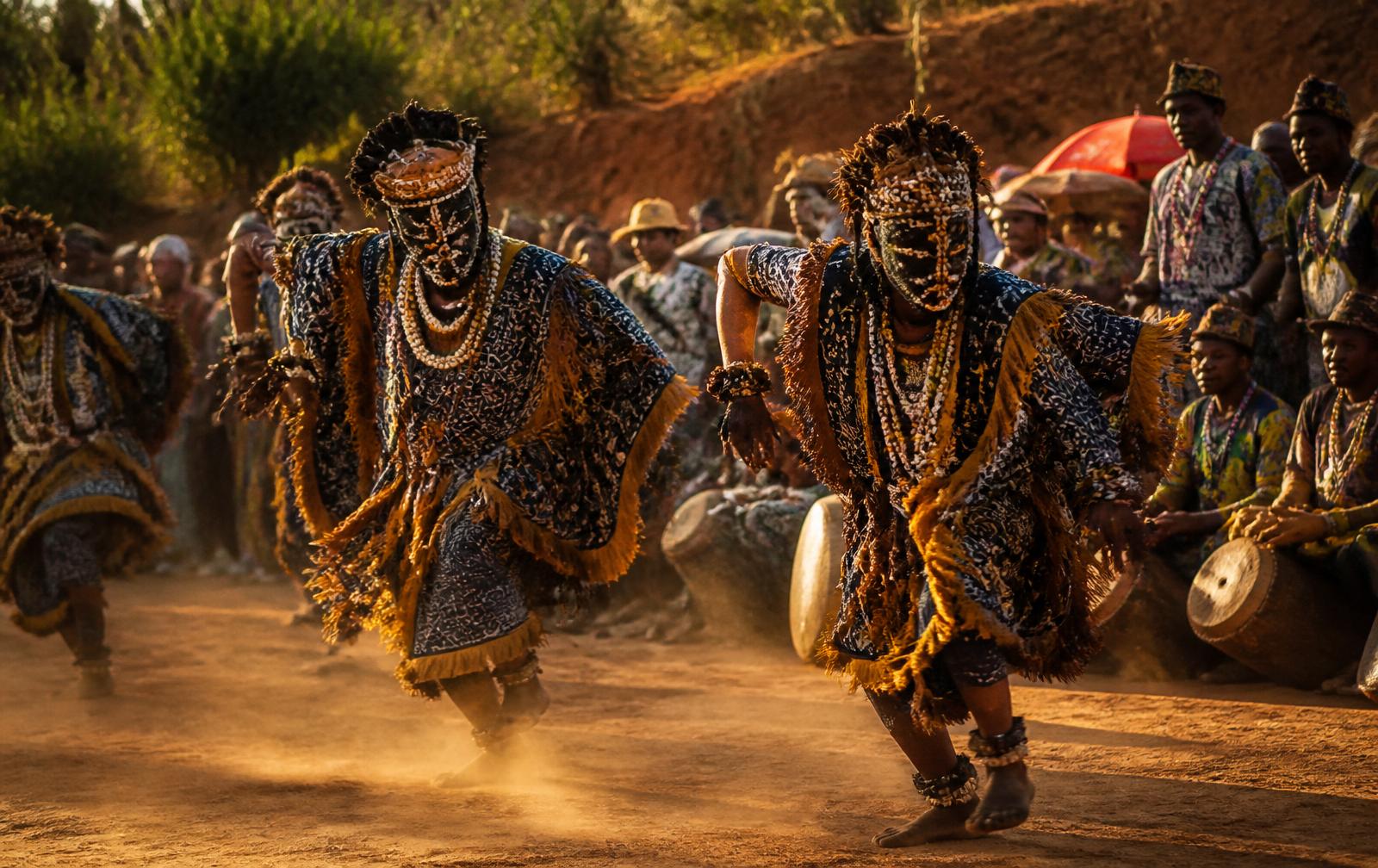 Masked Baméka dancers performing at a cultural festival